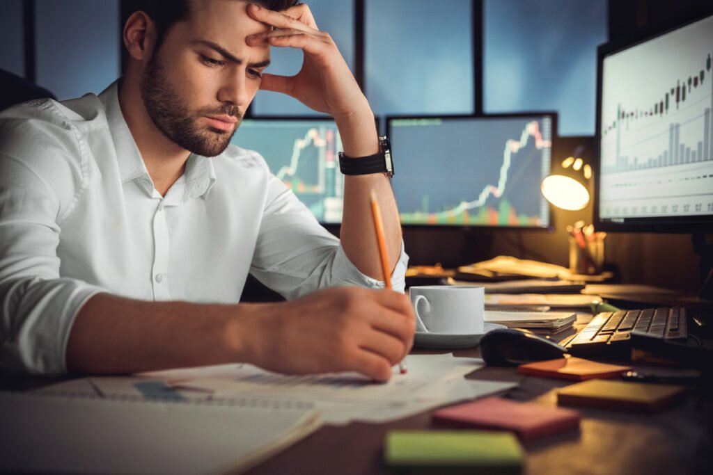 Serious businessman thinking hard about investing in a difficult market. Invest with displince, patience and education